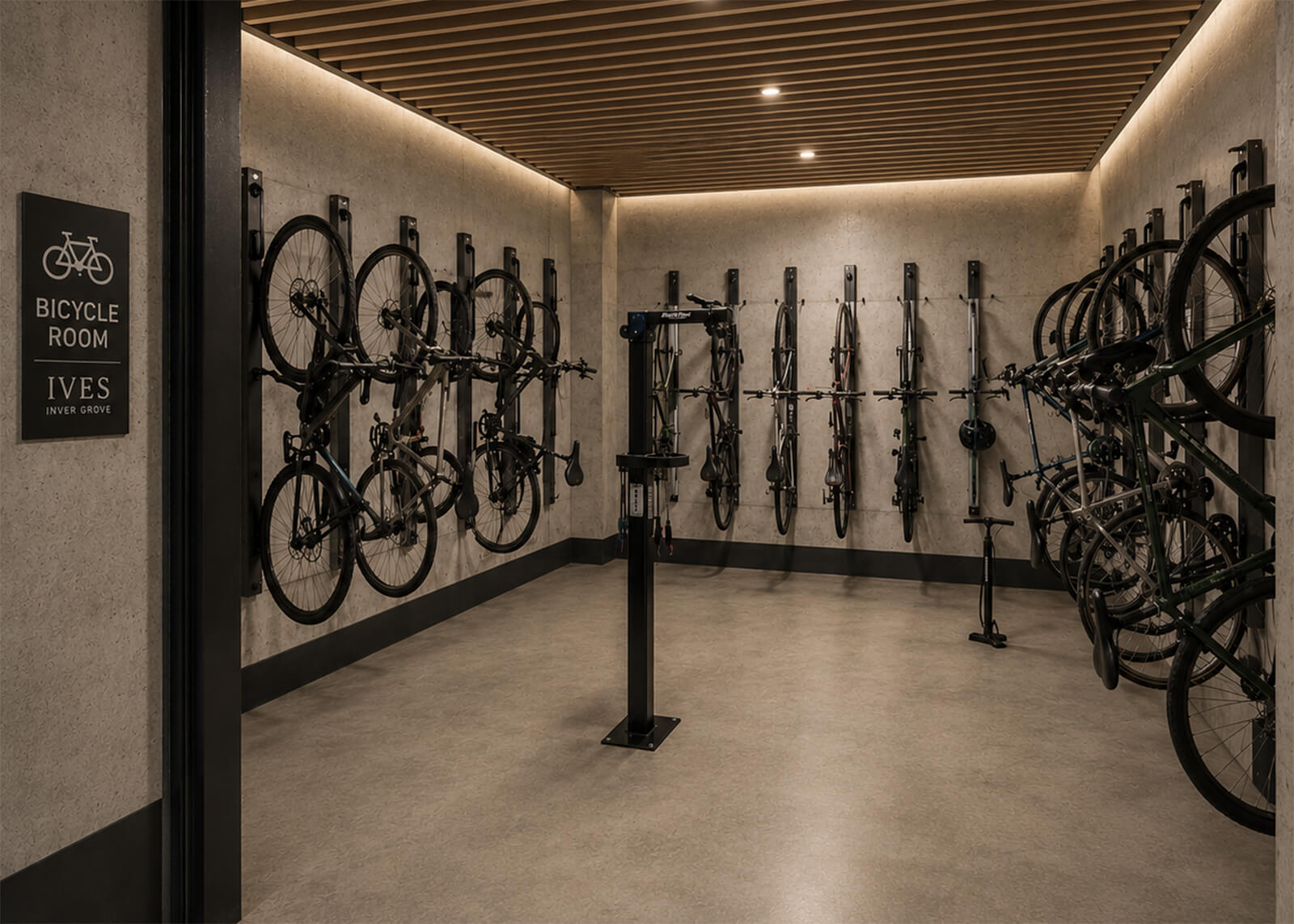 Bicycle storage room with wall-mounted bike racks, repair station, and Ives Inver Grove signage