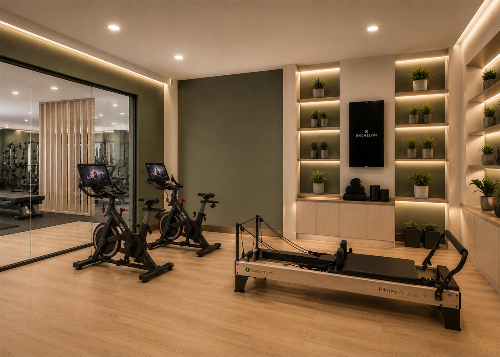 Fitness studio with Pilates reformer, spin bikes, wood flooring, mirrored wall, and backlit plant shelves