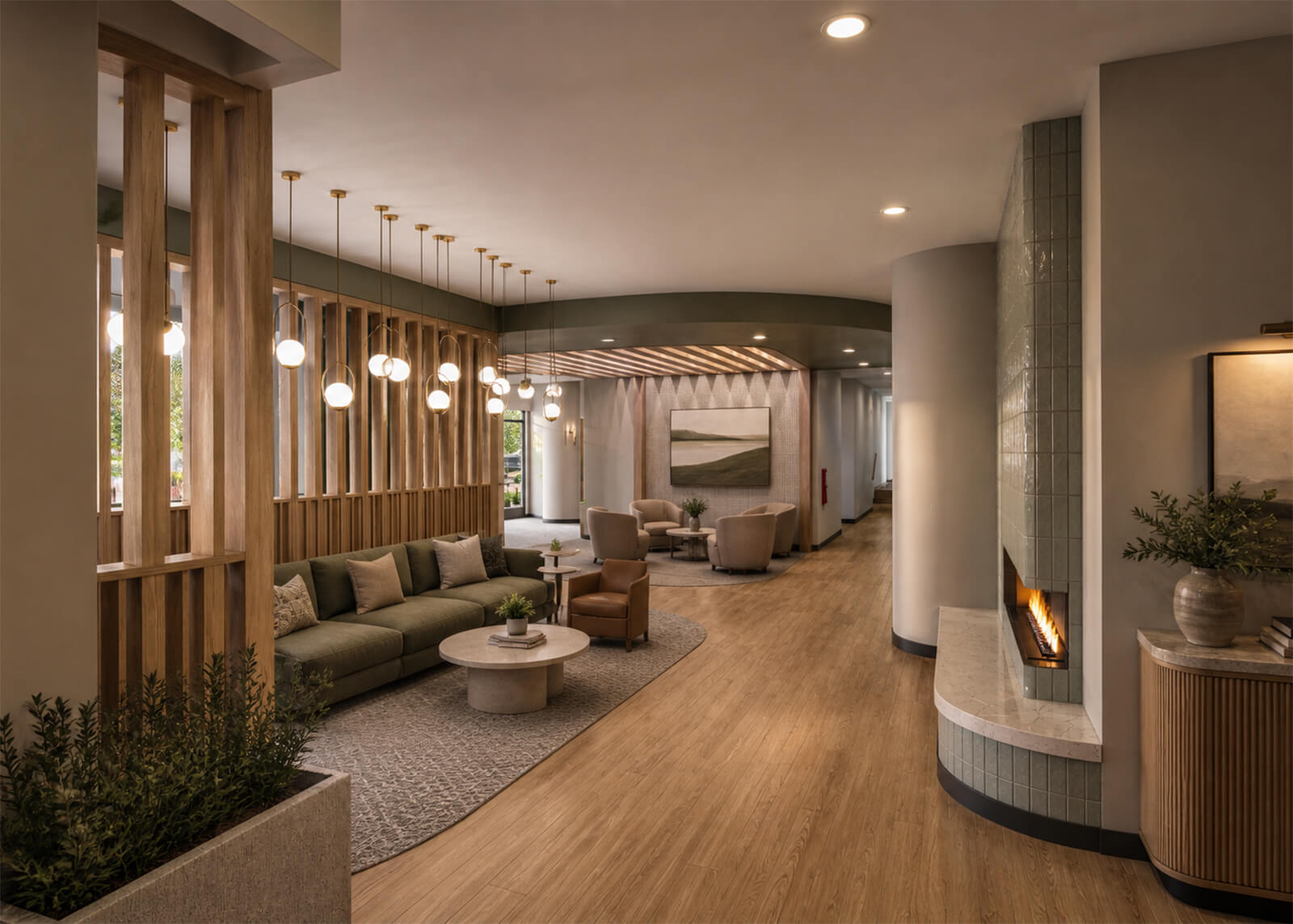 Lobby lounge with green sofa, wood accents, pendant lighting, fireplace, and seating areas