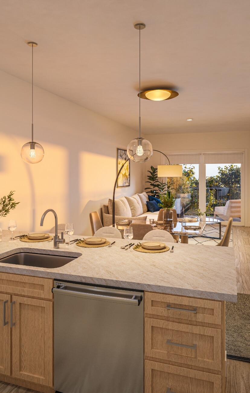 Modern apartment kitchen with island seating, pendant lights, and open living area leading to a balcony
