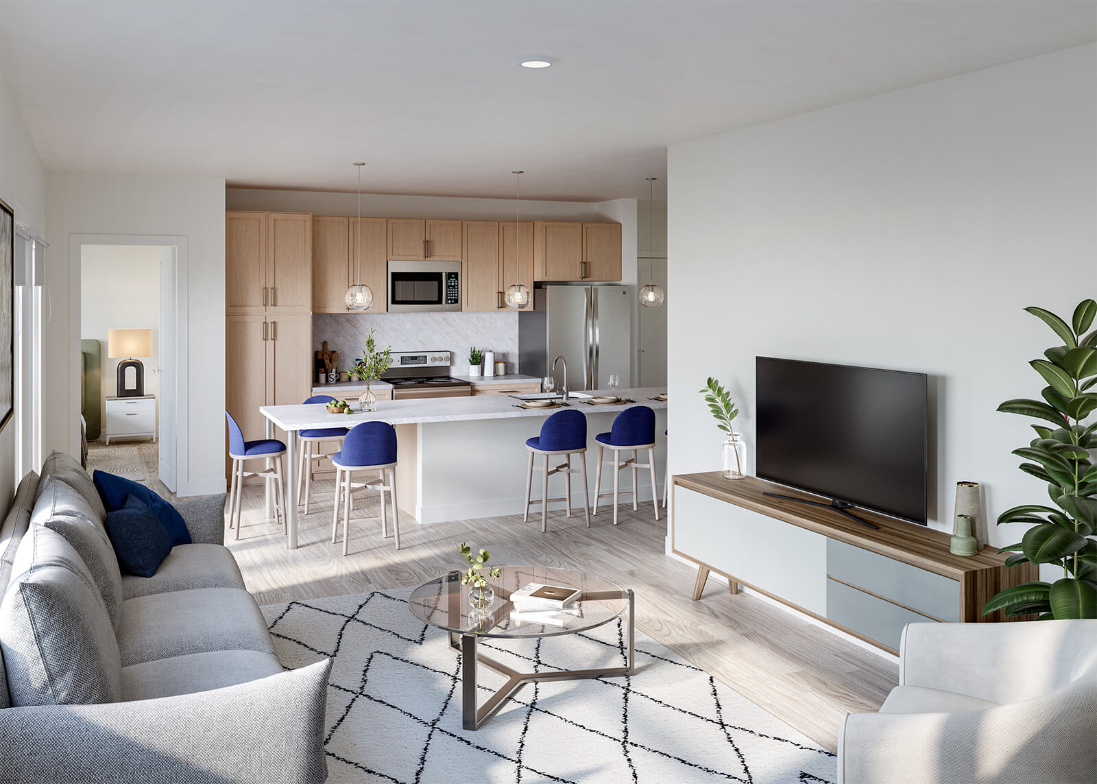 Bright apartment living room with sofa, TV, kitchen island, blue chairs, and open bedroom doorway