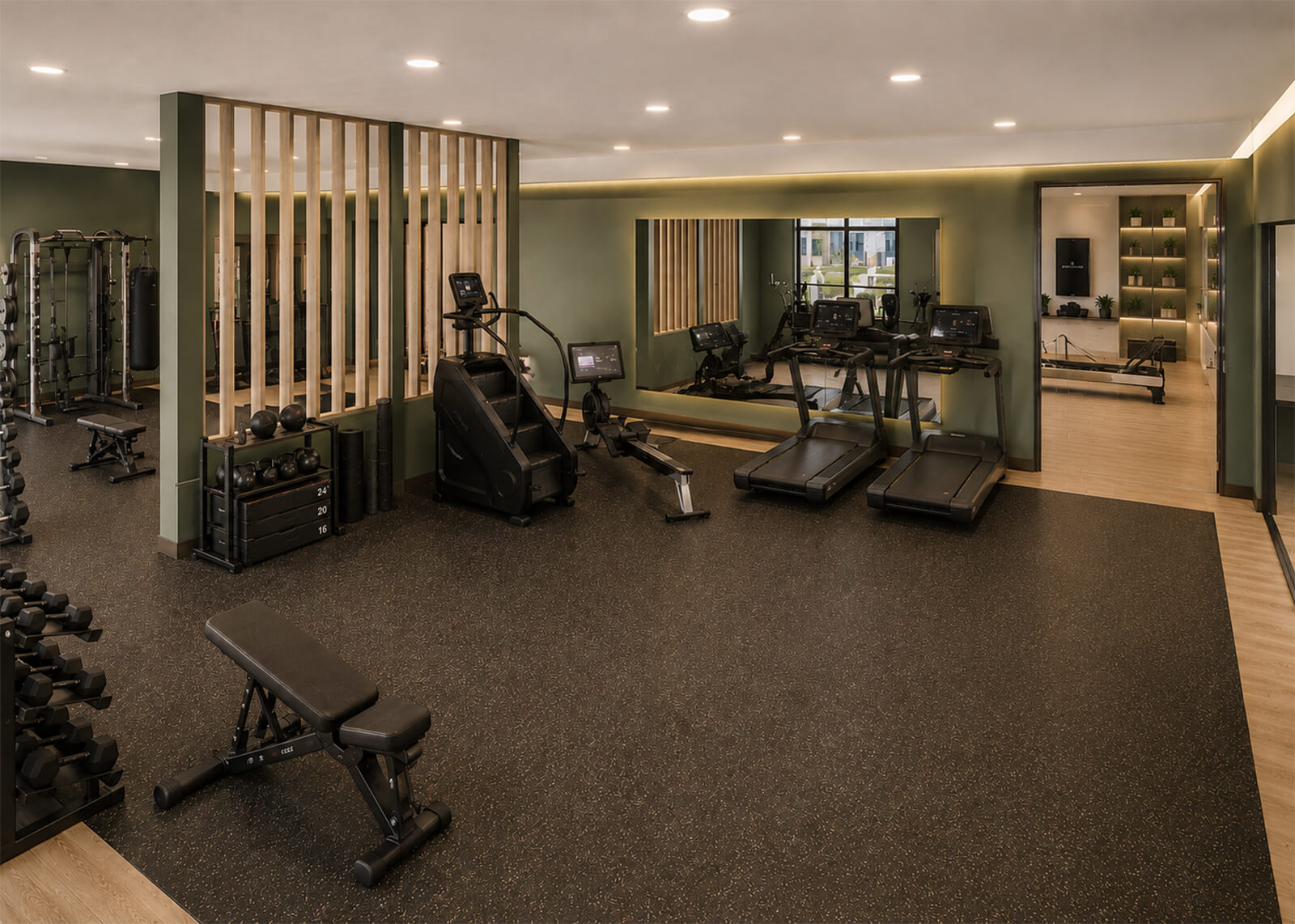 Apartment fitness center with treadmills, rowing machine, weights, strength equipment, and studio room